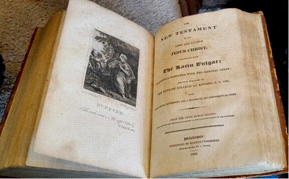 An open book with a picture of a person
Description automatically generated